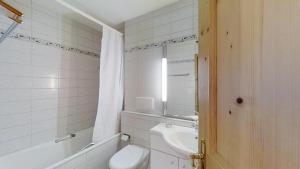 a bathroom with a toilet and a tub and a sink at La Planüra 11 in Maloja +20 photos
