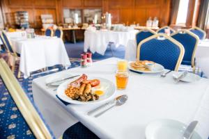 a white table topped with plates of food at The Royal Hotel Cardiff in Cardiff
