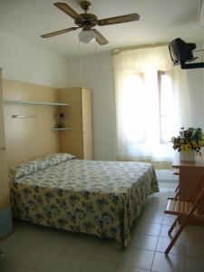 カンペーゼにあるHotel Giardino delle Palmeのベッドルーム1室(ベッド1台、シーリングファン付)