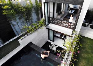 an aerial view of a house with a pool of water at eqUILIBRIA Seminyak - CHSE Certified in Seminyak