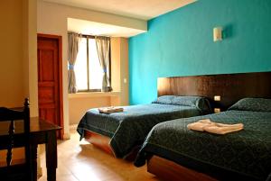 Postel nebo postele na pokoji v ubytování Hotel Real Colonial