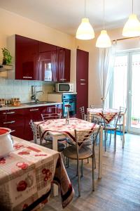 a kitchen with tables and chairs in a room at B&B Alfio Tomaselli in Nicolosi