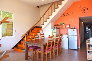 a kitchen with a table and chairs and a staircase at Ecotourism skim month B & B in Xiaoliuqiu