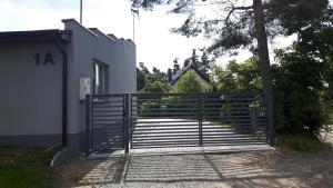 a gate in front of a house at Pueblo Apartamenty in Stegna
