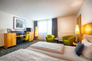 Postel nebo postele na pokoji v ubytování Offenbach Plaza Hotel