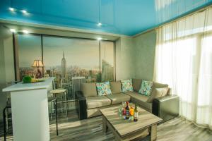 a living room with a couch and a table at Viva Blue Batumi in Batumi
