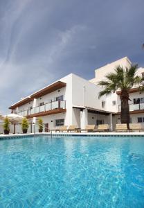 a large swimming pool in front of a building at Hotel Moli Boutique in Alfaz del Pi