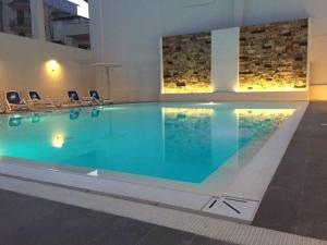 a large swimming pool in a hotel room at Hotel Miramare in Marina di Ragusa