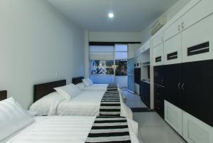 a large bedroom with two beds and a large closet at Hotel Torre del Viento cali in Cali +38 photos