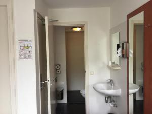 a bathroom with a sink and a toilet at Hotel Amsterdam Inn in Amsterdam