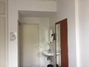 a bathroom with a sink and a mirror at Hotel Amsterdam Inn in Amsterdam