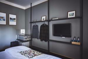 a room with a bed, television and a wall mounted wall mounted wall mounted at Josh Hotel in Bangkok