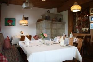 a dining room with two tables and a stone fireplace at Solhof-Schömberg in Loßburg