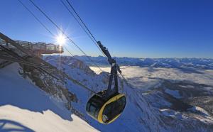 a gondola flying over a snow covered mountain at Panorama Appartement in Ramsau am Dachstein
