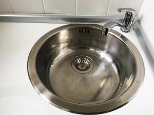 a stainless steel sink in a kitchen counter at Apartment Treetown in Regensburg +15 photos