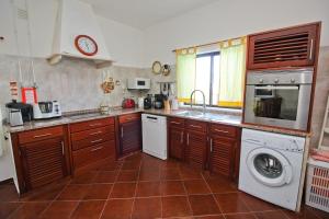 een keuken met een wastafel en een wasmachine bij Monte do Rio-Pêra in Pêra