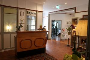 a lobby with a counter in a store at Hotel Deutsches Haus in Northeim