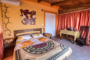 a bedroom with a king sized bed and a table at Casa di Luce in Aghia Marina