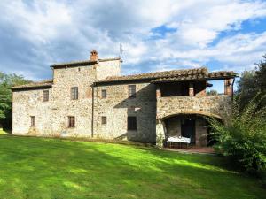 a large stone building with a grass yard at Authentic farm holiday with swimming pool pizza oven spacious garden and private terrace in Pietraviva