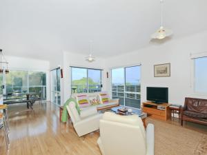 a living room with white furniture and a flat screen tv at Kiltevna - Maslin Beach - C21 SouthCoast Holidays in Maslin Beach