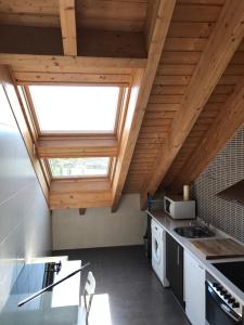 a kitchen with a skylight in the ceiling at Ático Balcon De Jaca II in Jaca