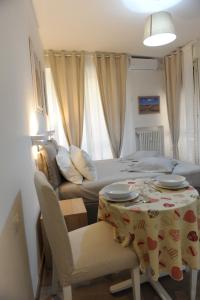 a small room with a bed and a table and chairs at Piccolo Borgo Antico in Florence