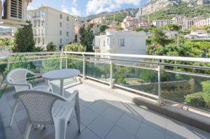 a balcony with a table and chairs and a view at Monte Carlo Terrace Monaco in Beausoleil