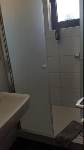 a bathroom with a glass shower door next to a sink at Hotel Alt Steinbach in Steinbach im Taunus