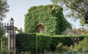 an ivy covered wall with a gate and a street light at Ch&acirc;teau Saint-Martin & Spa - an Oetker Collection Hotel in Vence