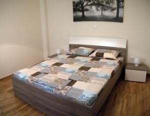 a bedroom with a bed with a quilt on it at ELITE apartment 5 min to Acropolis in Athens