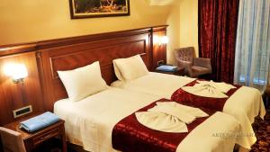 Postel nebo postele na pokoji v ubytování Artemis Resort Wellness Hotel