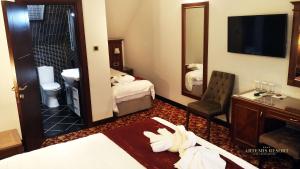 Postel nebo postele na pokoji v ubytování Artemis Resort Wellness Hotel