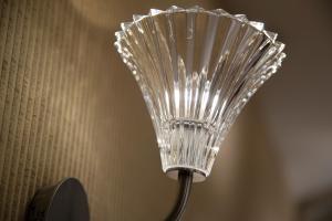 a close up of a silver fan on a wall at Hotel Ares Eiffel in Paris