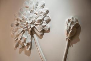 two white paper flowers on a wall at Hotel Ares Eiffel in Paris