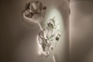 a black and white photo of two flowers on a wall at Hotel Ares Eiffel in Paris
