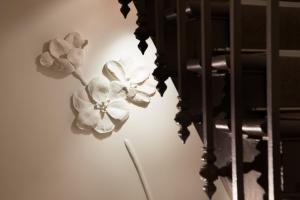 a pair of white flowers on a wall at Hotel Ares Eiffel in Paris