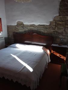 um quarto com uma cama grande e uma parede de pedra em Country house near Florence em Florença