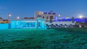 a villa with a view of a yard at night at Hotel Naturaleza Mar da Ardora Wellness & Spa in Finisterre