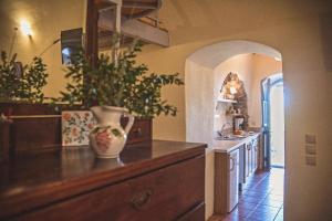 a kitchen with a vase on top of a dresser at Celestia Traditional Houses in Keramoto