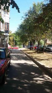 a street with cars parked on the side of the road at Visoki Stevan Apartments in Belgrade