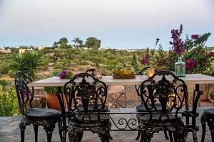 a table and chairs on a patio with a view at Celestia Traditional Houses in Keramoto