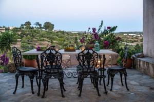 a table and chairs on a patio with a view at Celestia Traditional Houses in Keramoto