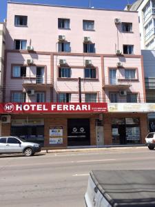 a building with a hotel rental sign in front of a street at Hotel Ferrari in Rio do Sul