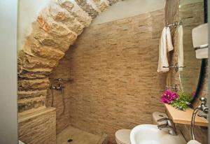 a bathroom with a shower and a sink at Celestia Traditional Houses in Keramoto