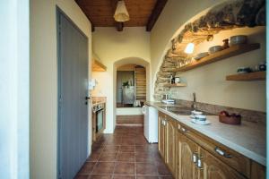 a kitchen with a sink and a counter top at Celestia Traditional Houses in Keramoto