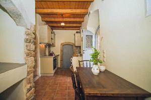 a kitchen with a wooden table in a room at Celestia Traditional Houses in Keramoto
