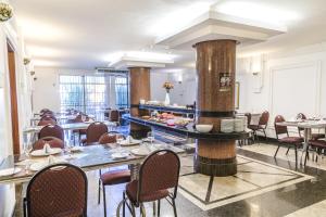 a restaurant with tables and chairs in a room at Monumental Bittar Hotel in Brasília