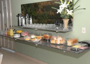 a counter with a bunch of food on it at Hotel Pousada Universitária in Teresina