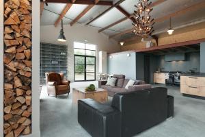 a living room with a couch and chairs and a kitchen at Camping 7Huizen aan Zee in Scharendijke