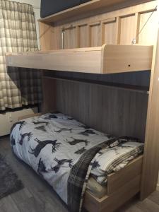 a bedroom with a bunk bed with a horse pattern at Bear Hutte Saalbach near Billa in Saalbach Hinterglemm